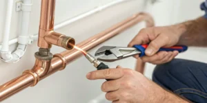 Soldering a copper water pipe to repair a leak.
